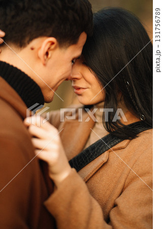 Young couple in love walking in the park on a autumn day. Enjoying time together. 131756789