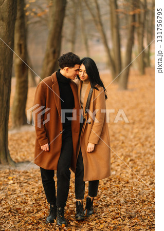 Young couple in love walking in the park on a autumn day. Enjoying time together. 131756795