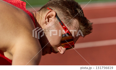 Close-up of runner wearing red sports sunglasses preparing for start Close-up of runner wearing red sports sunglasses preparing for start 131756819