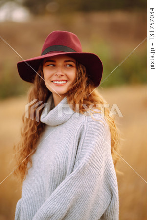 Stylish woman in hat enjoying autumn weather in the park. Fashion, style concept. Stylish woman in hat enjoying autumn weather in the park. Fashion, style concept. 131757034