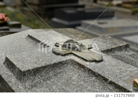 A head of Jesus Christ on a cross on a grave in a cemetery 131757660