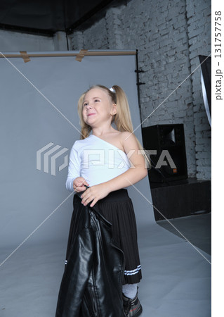 This cool young girl rocks a black leather jacket over a chic pleated skirt and lace socks, pairing it with a confident pose. Her fun and rebellious style channels rockstar energy, ideal for modern This cool young girl rocks a black leather jacket over a chic pleated skirt and lace socks, pairing it with a confident pose. Her fun and rebellious style channels rockstar energy, ideal for modern 131757758