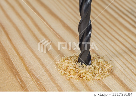Drill bit in a wooden board 131759194