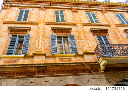 Old Italian balcony street in Rimini city Italy. Building architecture orange color houses in center 131759336