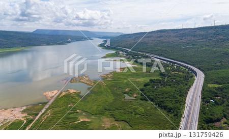Drone shot The M6 motorway Nakhon Ratchasima Province - Bang Pa-in Lam Ta Khong River and Mountain. Motorway Korat Thailand Drone shot The M6 motorway Nakhon Ratchasima Province - Bang Pa-in Lam Ta Khong River and Mountain. Motorway Korat Thailand 131759426