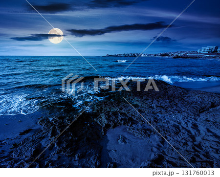 sunrise on a sandy town beach in mellow season at night. beautiful and warm weather on the shores of black sea. coast in full moon light 131760013