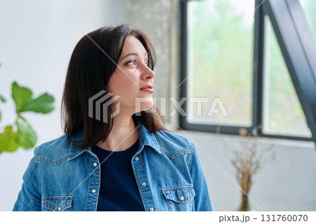 Headshot profile portrait of smiling woman 30 years old inside room at home Headshot profile portrait of smiling woman 30 years old inside room at home 131760070