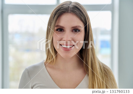 Headshot portrait of young happy woman looking at camera Headshot portrait of young happy woman looking at camera 131760133