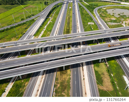 Drone shot a large highway interchange crossing over green farmlands in Thailand 131760264