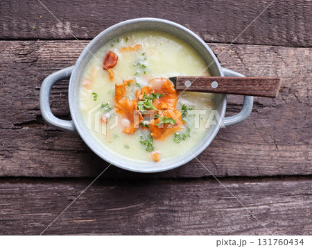 Cream soup with mushrooms chanterelles and herbs on a wooden background Cream soup with mushrooms chanterelles and herbs on a wooden background 131760434