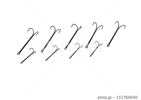 double hooks for fishing of various sizes on a white background close-up double hooks for fishing of various sizes on a white background close-up 131760640