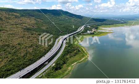 Drone shot The M6 motorway Nakhon Ratchasima Province - Bang Pa-in Lam Ta Khong River and Mountain. Motorway Korat Thailand Drone shot The M6 motorway Nakhon Ratchasima Province - Bang Pa-in Lam Ta Khong River and Mountain. Motorway Korat Thailand 131761412