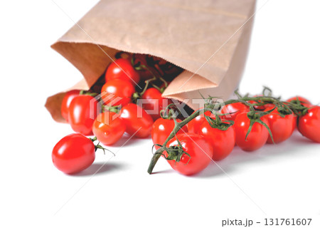 Cherry tomatoes on a branch, paper bag, light background, close-up Cherry tomatoes on a branch, paper bag, light background, close-up 131761607