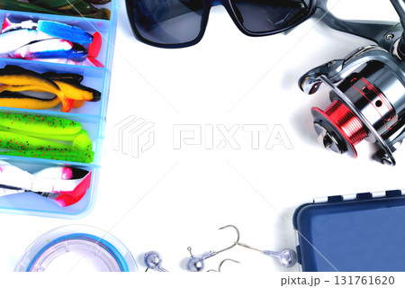 fishing accessories, box with silicone baits, fishing glasses, accessory box, fishing reel, hooks, braided fishing line on a white background, a place for copy space fishing accessories, box with silicone baits, fishing glasses, accessory box, fishing reel, hooks, braided fishing line on a white background, a place for copy space 131761620