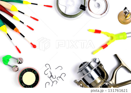 fishing accessories, accessory box, fishing reel, hooks, fishing line, floats on a white background, a place for copy space fishing accessories, accessory box, fishing reel, hooks, fishing line, floats on a white background, a place for copy space 131761621