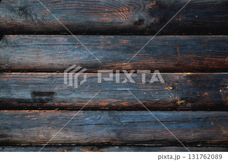 background from wooden logs of charred brown-black color 131762089
