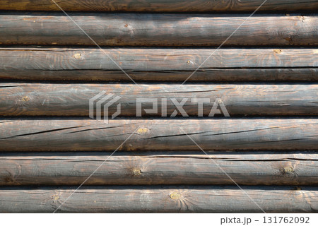 background from wooden natural logs of round brown color lit by the sun background from wooden natural logs of round brown color lit by the sun 131762092