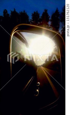 car mirror reflection of the morning sun in the mirror the terrain in the background car mirror reflection of the morning sun in the mirror the terrain in the background 131762120