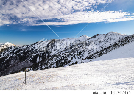 Snowy mountain range under a bright blue sky. The Mala Fatra national park in northwest of Slovakia, Europe. Snowy mountain range under a bright blue sky. The Mala Fatra national park in northwest of Slovakia, Europe. 131762454