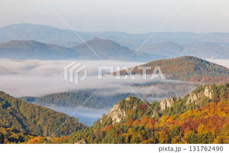 Autumn mountains landscape with colorful foliage, trees, forest hills and fog shrouded valleys in scenic rural area aerial view. The Sulov Rocks, national nature reserve in Slovakia, Europe. 131762490