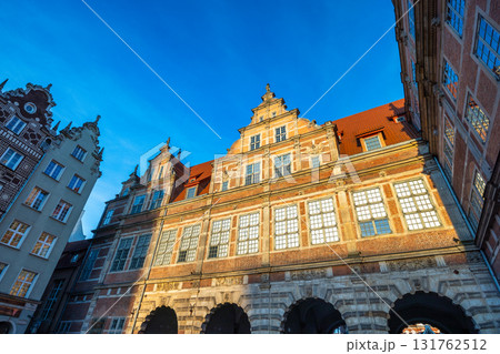 Gdansk, the Green Gate in a city on the Baltic coast of northern Poland, Europe. Low-angle view of historic architecture. Warm light bathes detailed facades. 131762512