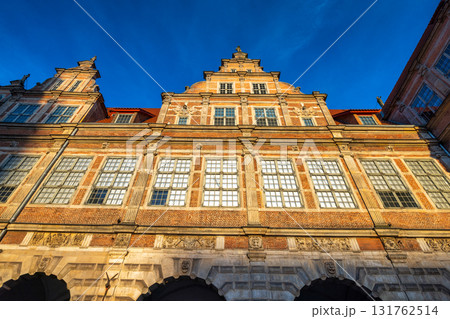 Gdansk, the Green Gate in a city on the Baltic coast of northern Poland, Europe. Ornate Building Exterior: A detailed facade with grand windows under clear blue sky showcasing architectural grandeur. Gdansk, the Green Gate in a city on the Baltic coast of northern Poland, Europe. Ornate Building Exterior: A detailed facade with grand windows under clear blue sky showcasing architectural grandeur. 131762514