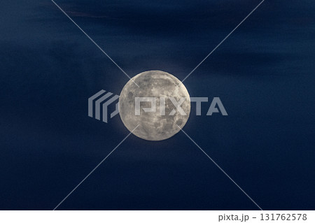 Lunar sphere: The moon glows in the dark night sky, its surface features captured in exquisite detail. 131762578