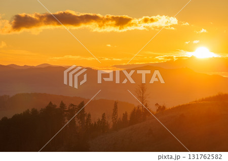 Golden hour lights up the mountains, with a sky ablaze in warm hues during a breathtaking sunrise. Golden hour lights up the mountains, with a sky ablaze in warm hues during a breathtaking sunrise. 131762582