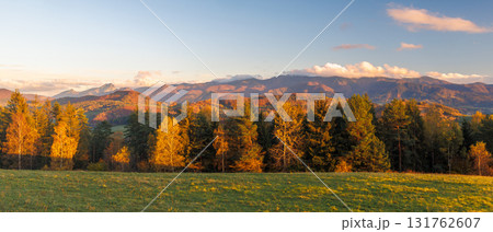 Autumn mountains and forest at sunrise. Green meadow, golden trees, majestic peaks in the distance. The Mala Fatra national park in Slovakia, Europe. Autumn mountains and forest at sunrise. Green meadow, golden trees, majestic peaks in the distance. The Mala Fatra national park in Slovakia, Europe. 131762607