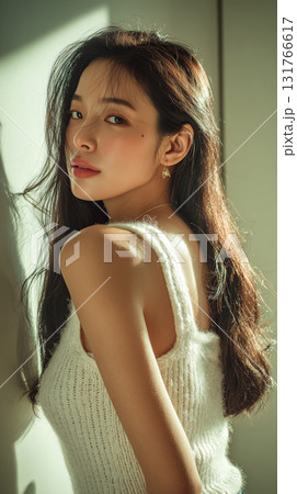 Beautiful Korean woman with long hair poses elegantly in natural light, showcasing her style and grace in a serene setting 131766617