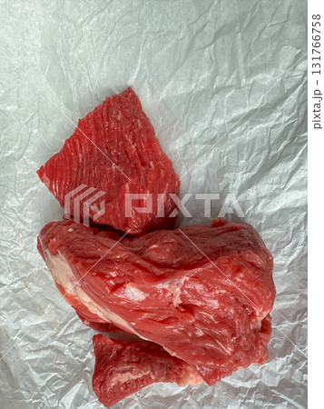 Raw beef steak on parchment paper, top view food background with copy space Raw beef steak on parchment paper, top view food background with copy space 131766758