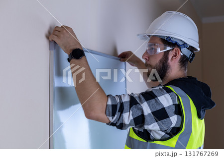 Man in hard hat and safety vest inspecting construction site Man in hard hat and safety vest inspecting construction site 131767269