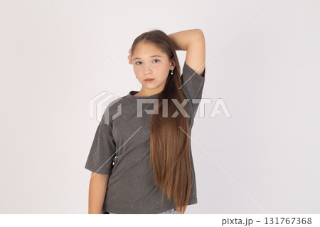 Woman is posing for a photo with her right hand behind her head 131767368