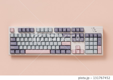 Modern mechanical keyboard on light pink background. Minimal style and design keyboard. Custom build keyboard. Colorful pastel creamy pink and green key cap. Top view. Modern mechanical keyboard on light pink background. Minimal style and design keyboard. Custom build keyboard. Colorful pastel creamy pink and green key cap. Top view. 131767452