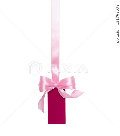 Pink satin ribbon with bow and attached gift tag isolated on white background. Ideal for packaging, gifts, labels and sale promotions. 131768038