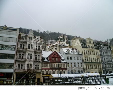 City streets, Baroque buildings, and a colonnade in winter. Snow creates a special atmosphere in the spa town. 131768070