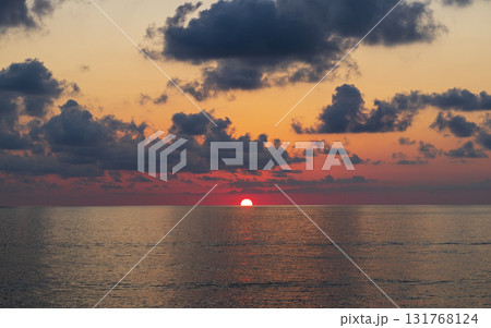 Shot of the dramatic sunset by the beach. Shot of the dramatic sunset by the beach. 131768124