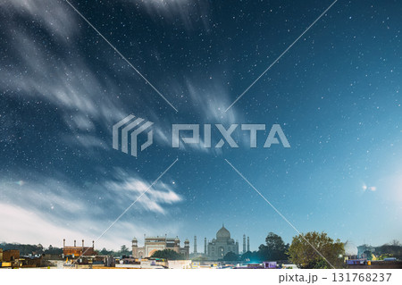 Taj Mahal In Agra, Uttar Pradesh, India. Night view Of Taj Mahal. Seven World Wonders. Night stars above Fabulous Taj Mahal Travel Concept. Indian Islamic Heritage At Night Time Taj Mahal In Agra, Uttar Pradesh, India. Night view Of Taj Mahal. Seven World Wonders. Night stars above Fabulous Taj Mahal Travel Concept. Indian Islamic Heritage At Night Time 131768237