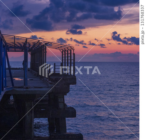 Abstract shot of the metal construction bars with cloudy sunset sky on the background 131768337