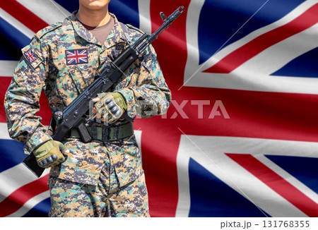 Great britain flag with soldier holding assault rifle 131768355