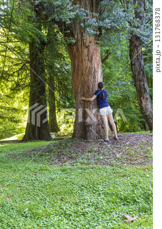 Woman hugging the tree in the arboretum 131768378