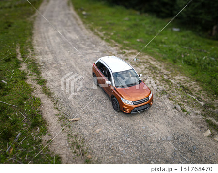 Aerial view of SUV running on the moutain road in Carpathians Mountains, Ukraine 131768470