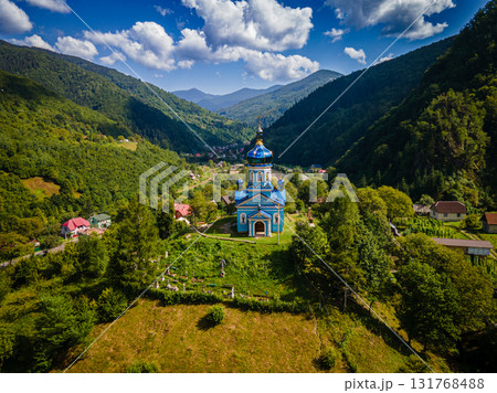 Aerial view of blue orthodox church surrounded by Carpathians Mountains. High quality photo Aerial view of blue orthodox church surrounded by Carpathians Mountains. High quality photo 131768488