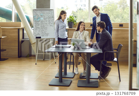 Corporate team working together, meeting in office and discussing business project Corporate team working together, meeting in office and discussing business project 131768709