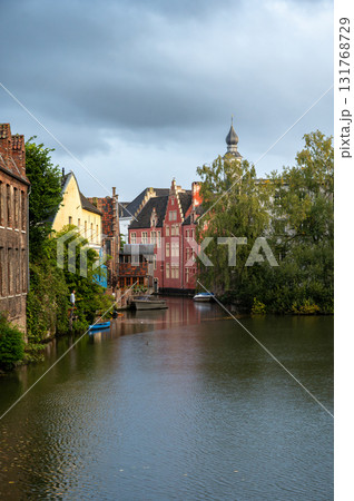 Canal-side buildings of Ghent showcasing medieval facades and soft reflections on the water. 131768729