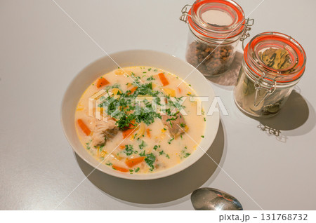 Traditional Belgian Waterzooi dish close-up, featuring creamy broth with fish, seafood, potatoes, and vegetables - a classic comfort food from Belgium. Traditional Belgian Waterzooi dish close-up, featuring creamy broth with fish, seafood, potatoes, and vegetables - a classic comfort food from Belgium. 131768732