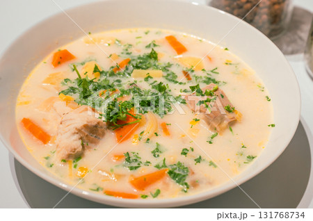 Traditional Belgian Waterzooi dish close-up, featuring creamy broth with fish, seafood, potatoes, and vegetables - a classic comfort food from Belgium. 131768734