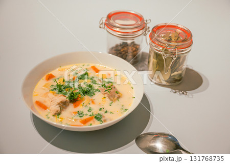 Traditional Belgian Waterzooi dish close-up, featuring creamy broth with fish, seafood, potatoes, and vegetables - a classic comfort food from Belgium. Traditional Belgian Waterzooi dish close-up, featuring creamy broth with fish, seafood, potatoes, and vegetables - a classic comfort food from Belgium. 131768735