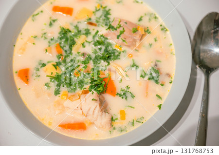 Traditional Belgian Waterzooi dish close-up, featuring creamy broth with fish, seafood, potatoes, and vegetables - a classic comfort food from Belgium. 131768753