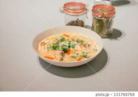 Traditional Belgian Waterzooi dish close-up, featuring creamy broth with fish, seafood, potatoes, and vegetables - a classic comfort food from Belgium. Traditional Belgian Waterzooi dish close-up, featuring creamy broth with fish, seafood, potatoes, and vegetables - a classic comfort food from Belgium. 131768768